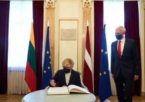 Prime Minister of Lithuania Ingrida Šimonytė is writing an entry in the guest book of the Cabinet of Ministers. 