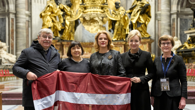 Ministru prezidente Evika Siliņa un Latvijas svētceļojuma dalībnieki ar Latvijas karogu Pētera bazilikā Vatikānā