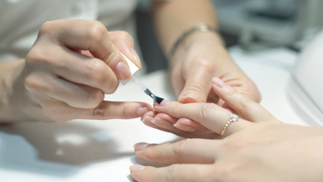 ilustratīvs attēls: meistare veic manikīru; avots: 123rf.com