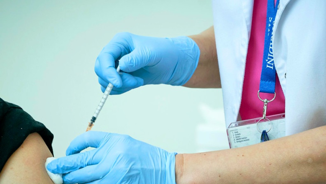 Cilvēks tiek vakcinēts plecā