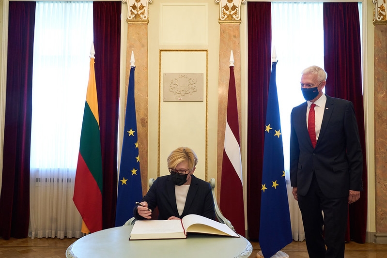 Prime Minister of Lithuania Ingrida Šimonytė is writing an entry in the guest book of the Cabinet of Ministers. 
