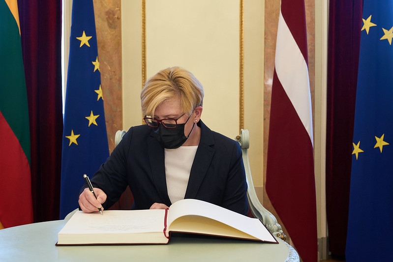 Prime Minister of Lithuania Ingrida Šimonytė is writing an entry in the guest book of the Cabinet of Ministers. 