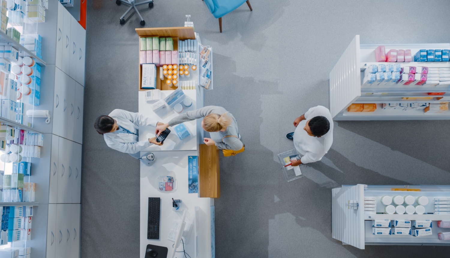 Aptieka. Farmaceits un klienti aptiekā. Skats no augšas. 