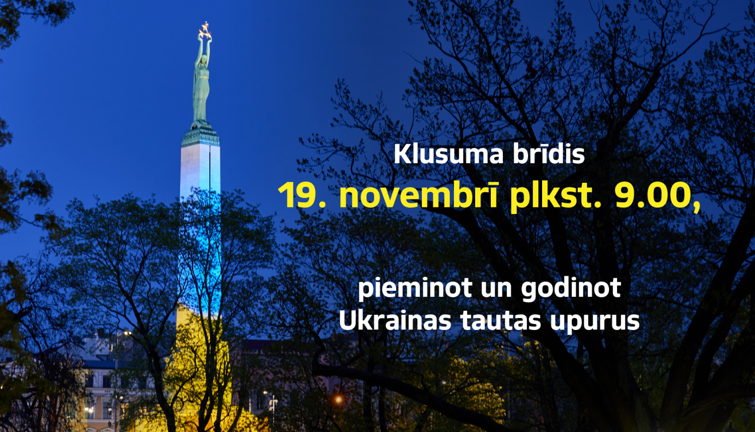 Foto ar Brīvības pieminekli, kas izgaismots Ukrainas karoga krāsās. Aicinājums pieminēt un godināt Ukrainas tautas upurus 19. novembrī pllkst. 9.00
