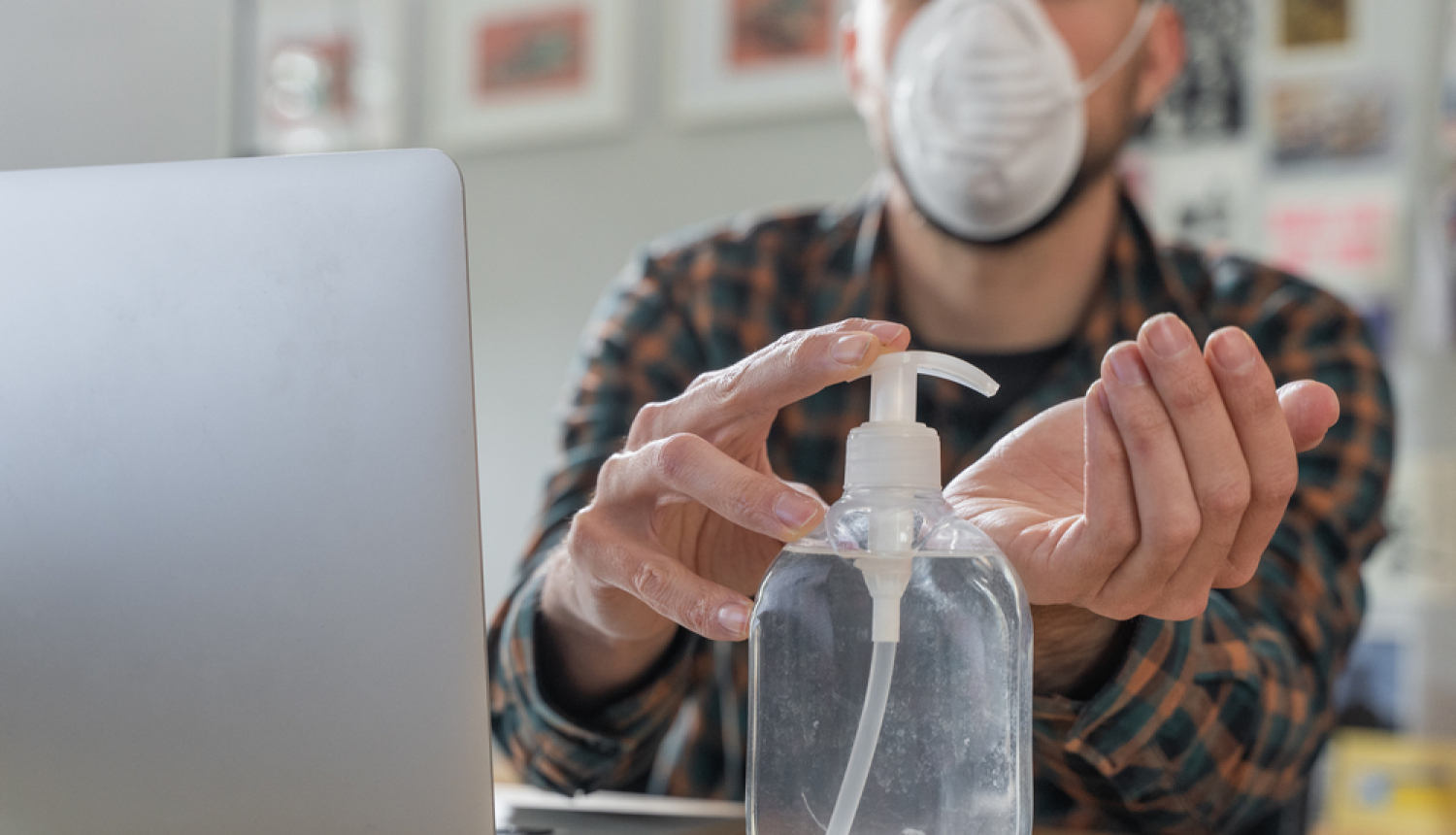 Vīrietis maskā dezifincē rokas