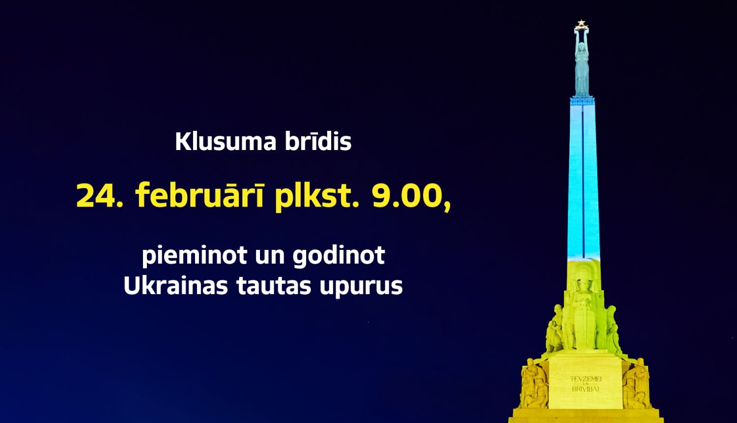 Brīvības piemineklis izgaismots Ukrainas karoga krāsās un teksts "Klusuma brīdis 24. februārī plkst.9.00, pieminot un godinot Ukrainas tautas upurus"